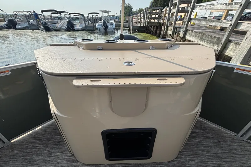 Slide: The Image of 2024 Godfrey SW2286FS boat at dock, featuring a beige console with measurement markings. - 11