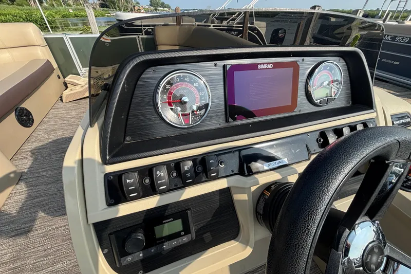 Slide: The Image of 2024 Godfrey SW2286FS boat dashboard with steering wheel, gauges, and control panel. - 5