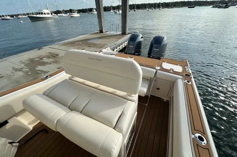 Slide: The Image of 2019 Grady-White Fisherman 257 boat docked, featuring dual engines and luxurious seating. - 12