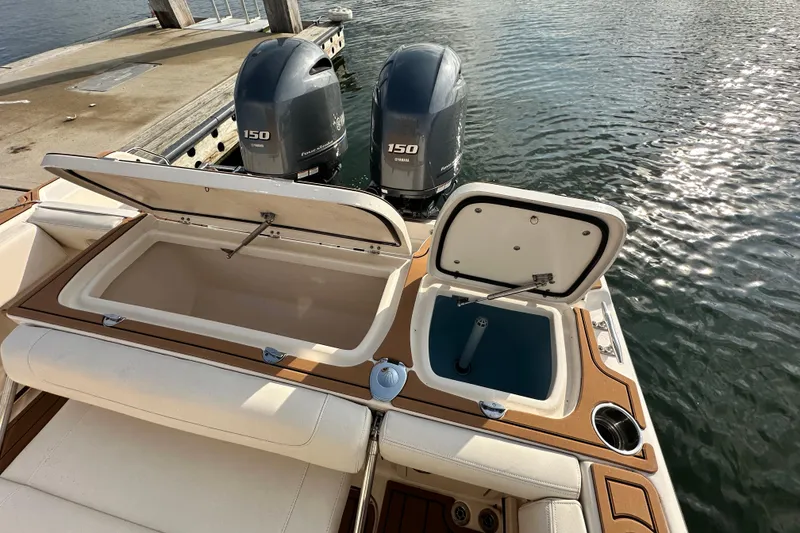 Slide: The Image of 2019 Grady-White Fisherman 257 boat with open storage compartments and twin Yamaha 150 engines. - 13