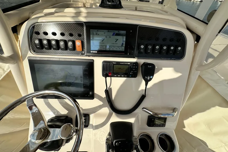 Slide: The Image of 2019 Grady-White Fisherman 257 dashboard with navigation and control systems. - 16