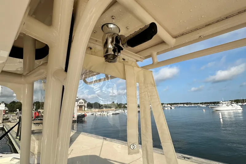 Slide: The Image of 2019 Grady-White Fisherman 257 interior view at marina with boats and clear sky. - 17