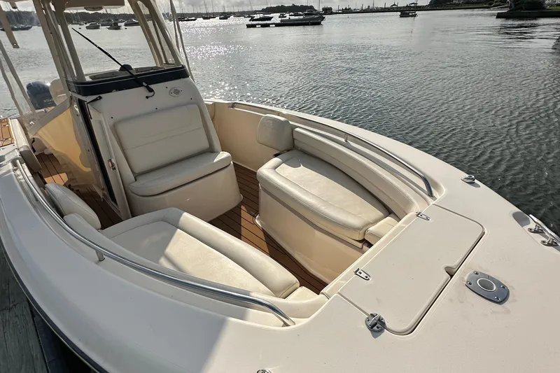 Slide: The Image of 2019 Grady-White Fisherman 257 boat with cushioned seating, docked on calm water. - 5