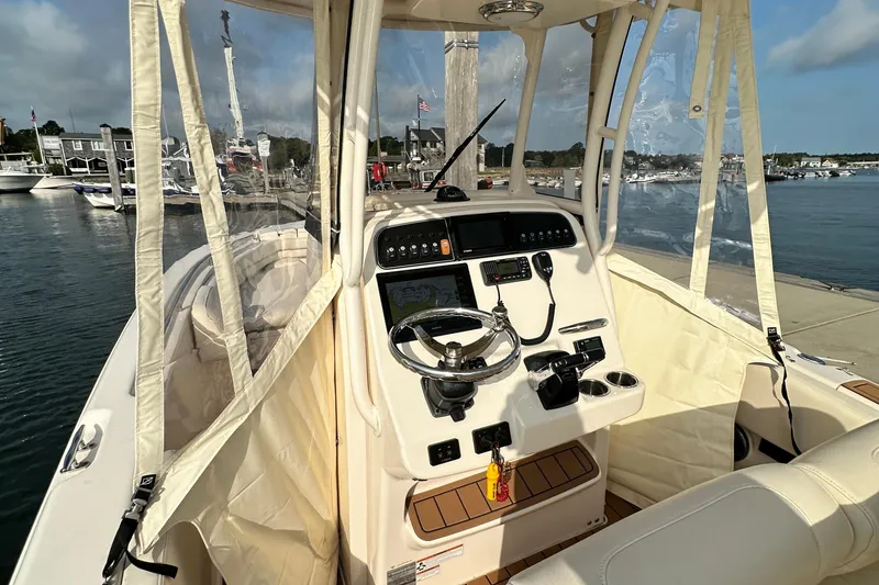 Slide: The Image of 2019 Grady-White Fisherman 257 boat interior with helm, docked at marina. - 9