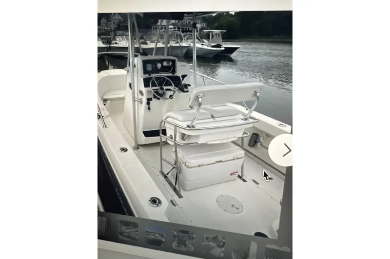 Slide: The Image of 2002 Boston Whaler 21 Outrage boat interior with steering console and seating. - 10