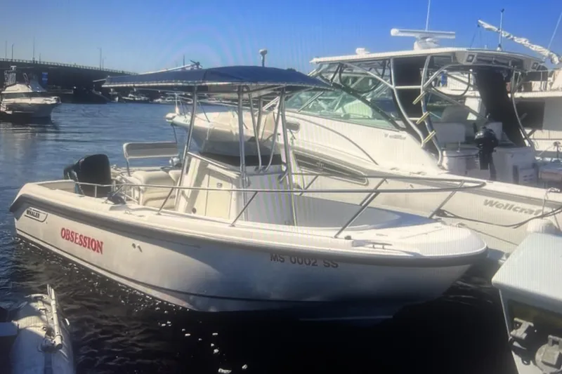 Slide: The Image of 2002 Boston Whaler 21 Outrage boat docked in marina, sunny day. - 4