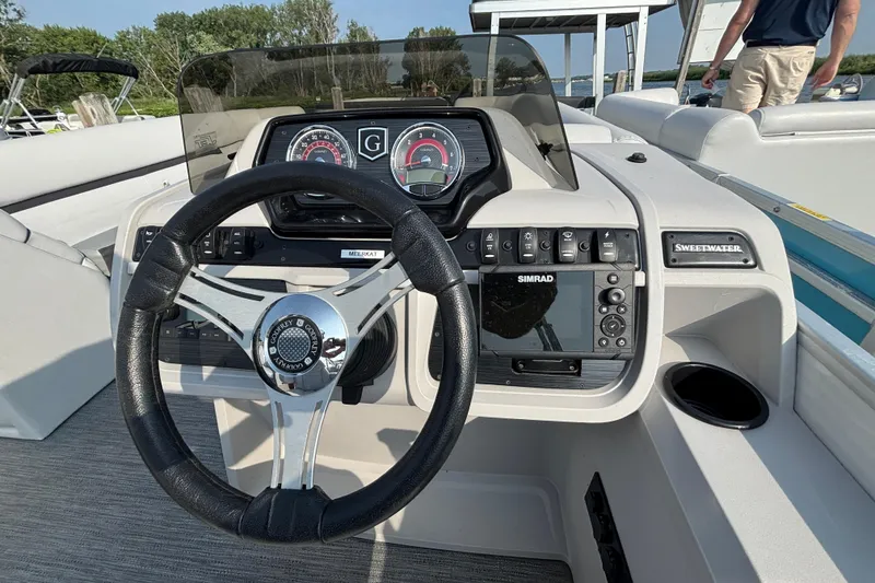 Slide: The Image of Steering console of 2024 Godfrey Sweetwater SW2286SB boat with Simrad display and gauges. - 7