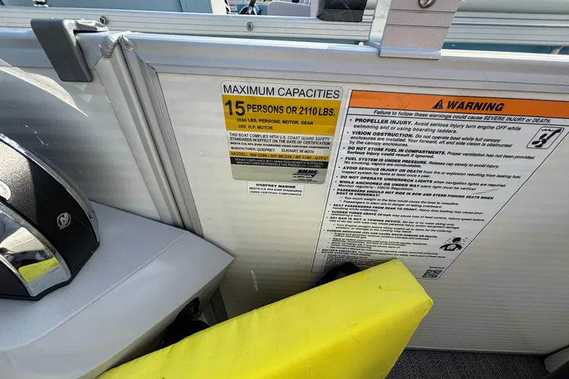 Slide: The Image of 2024 Godfrey Sw2286SB boat capacity and safety warning labels, maximum 15 persons or 2110 lbs. - 9