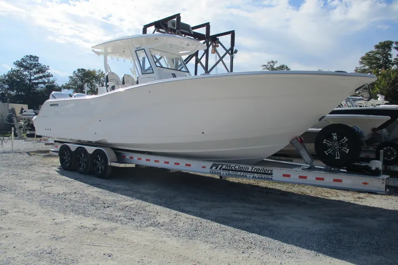Slide: The Image of 2026 Sea Fox 328 Commander boat on trailer, parked outdoors under a cloudy sky. - 1