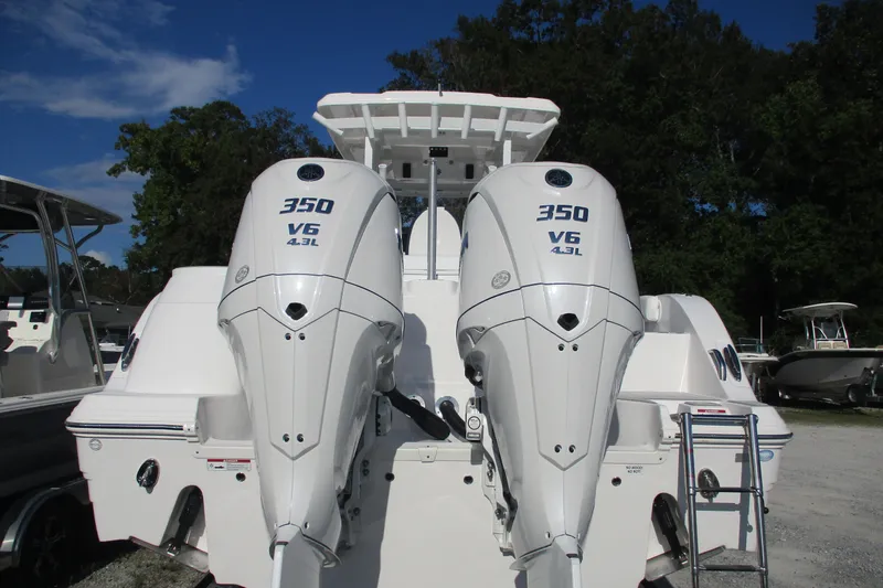Slide: The Image of 2026 Sea Fox 328 Commander with twin 350 V6 outboard engines, docked outdoors. - 10