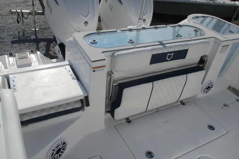 Slide: The Image of 2026 Sea Fox 328 Commander boat deck with seating and storage features. - 12