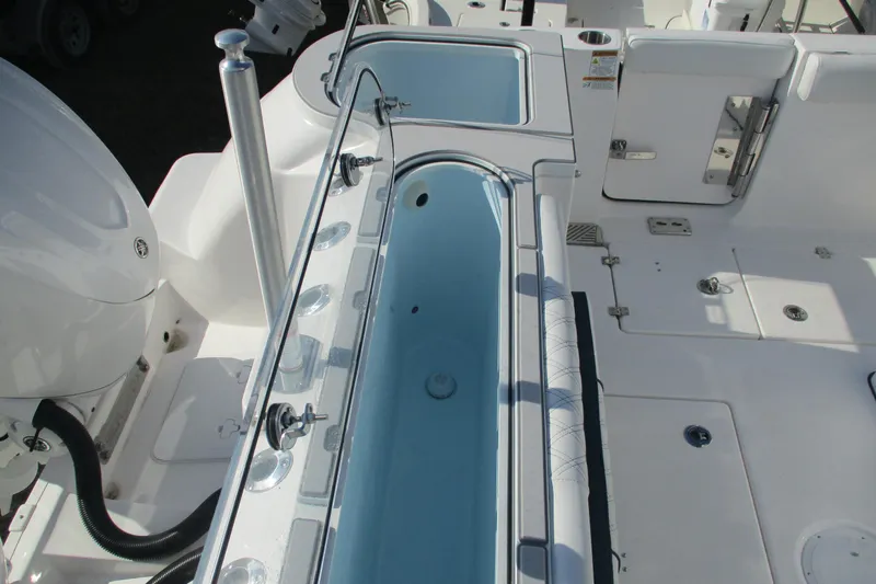 Slide: The Image of 2026 Sea Fox 328 Commander boat deck with livewell and storage compartments. - 14