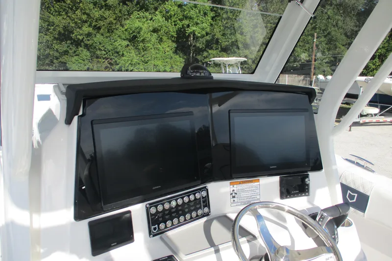 Slide: The Image of 2026 Sea Fox 328 Commander dashboard with dual screens and steering wheel. - 17