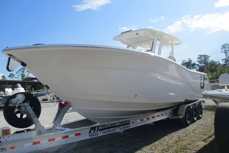 Slide: The Image of 2026 Sea Fox 328 Commander boat on trailer under clear blue sky. - 2