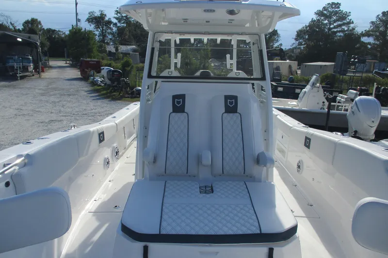 Slide: The Image of 2026 Sea Fox 328 Commander boat interior with white seating and console. - 20