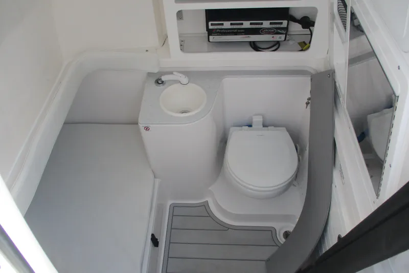 Slide: The Image of 2026 Sea Fox 328 Commander boat bathroom with toilet and sink. - 24