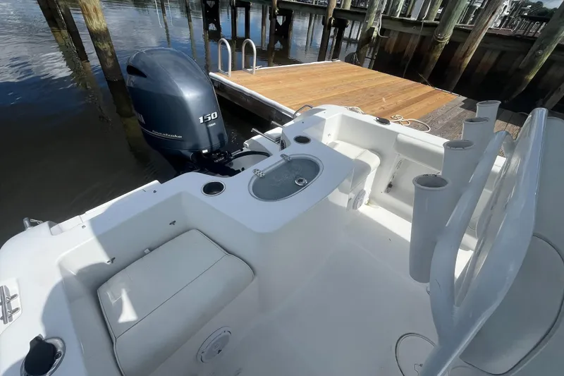 Slide: The Image of 2020 Sea Hunt Triton 210 boat with Yamaha 150 engine docked at marina. - 11