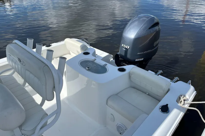 Slide: The Image of 2020 Sea Hunt Triton 210 boat with Yamaha 150 engine on calm water. - 6