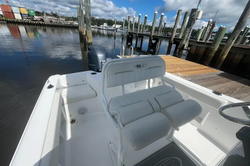 Slide: The Image of 2020 Sea Hunt Triton 210 boat docked, featuring comfortable seating and Yamaha 150 engine. - 7
