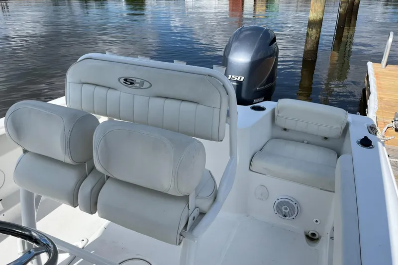 Slide: The Image of 2020 Sea Hunt Triton 210 boat interior with seating and Yamaha 150 outboard motor. - 9