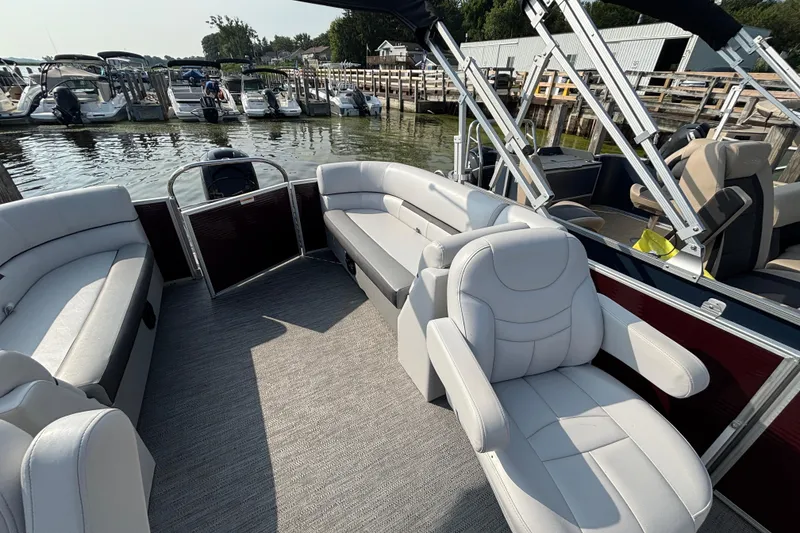 Slide: The Image of 2024 Godfrey Sw2286SB pontoon boat with spacious seating at a marina dock. - 7