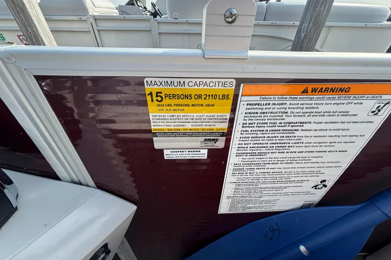 Slide: The Image of 2024 Godfrey Sw2286SB boat capacity warning label, maximum 15 persons or 2110 lbs. - 8