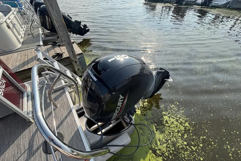 Slide: The Image of 2024 Godfrey Sw2286SB boat with Mercury outboard motor docked on a sunny day. - 9