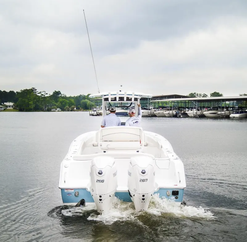 Slide: The Image of 2025 Sea Hunt Ultra 275 SE boat cruising on a calm lake. - 1