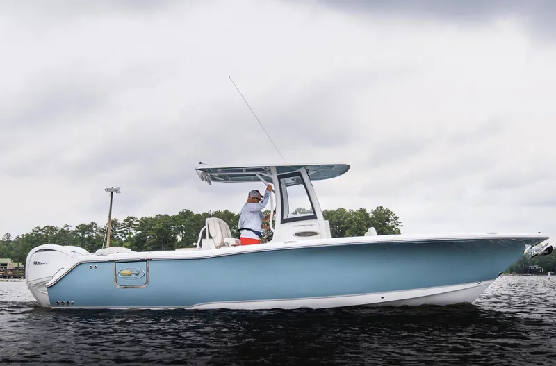 Slide: The Image of 2025 Sea Hunt Ultra 275 SE boat on calm water, overcast sky. - 13