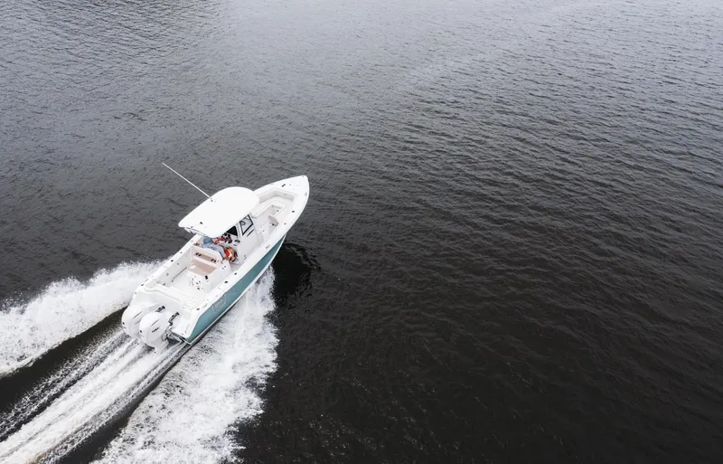 Slide: The Image of Aerial view of 2025 Sea Hunt Ultra 275 SE boat cruising on open water. - 16