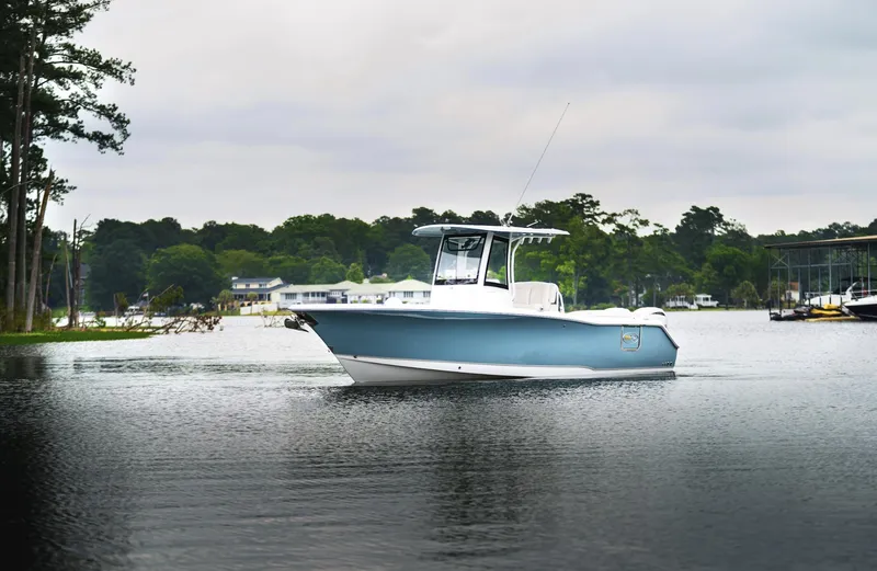 Slide: The Image of 2025 Sea Hunt Ultra 275 SE boat on a serene lake. - 17