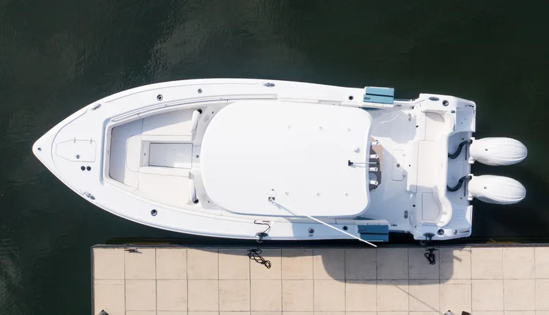 Slide: The Image of Aerial view of 2025 Sea Hunt Ultra 275 SE boat docked at marina. - 2