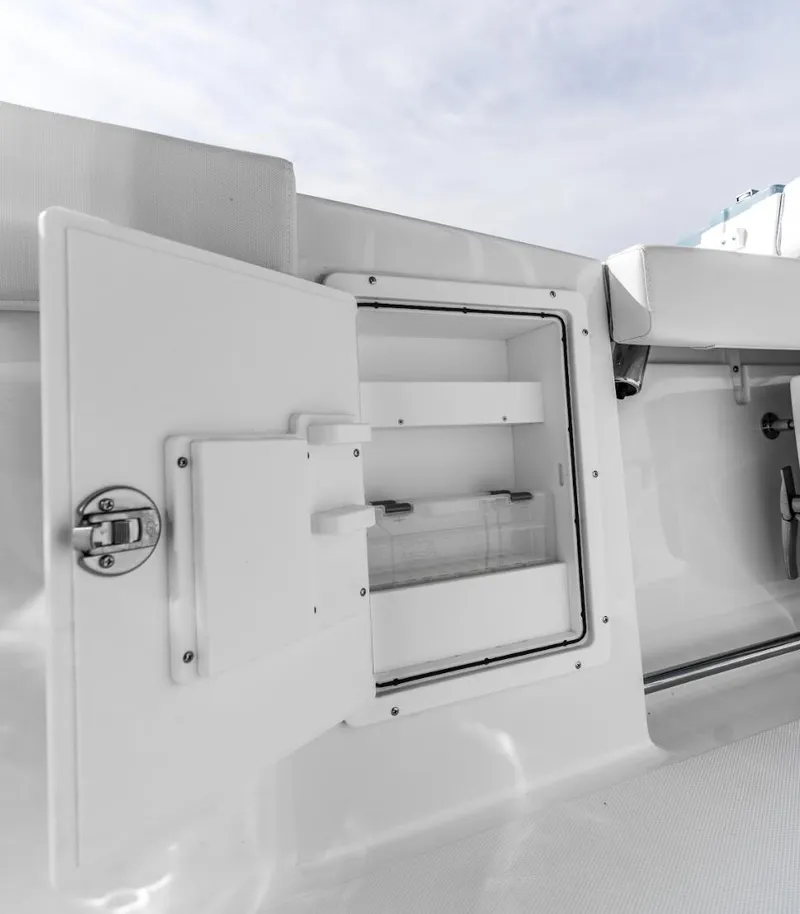 Slide: The Image of 2025 Sea Hunt Ultra 275 SE boat storage compartment with open door. - 7