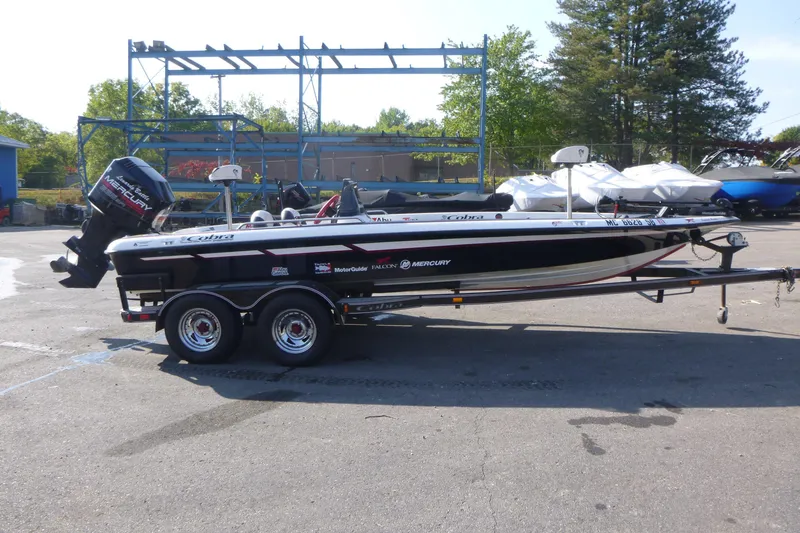 Slide: The Image of 1999 Viper Boats Cobra 201 on trailer, parked outdoors with Mercury engine. - 1