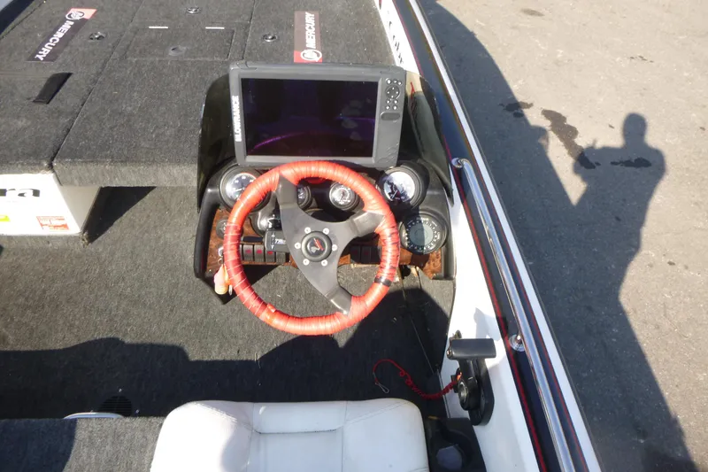 Slide: The Image of 1999 Viper Boats Cobra 201 dashboard with red steering wheel and navigation system. - 10