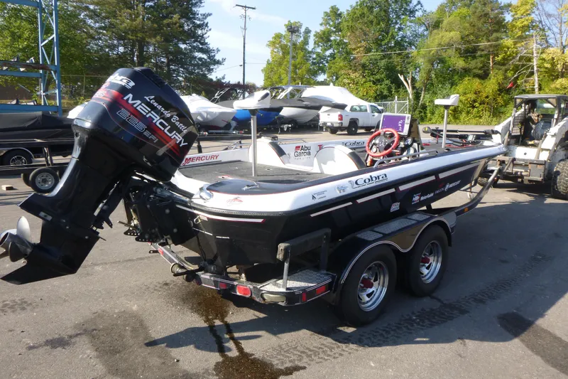 Slide: The Image of 1999 Viper Boats Cobra 201 with Mercury engine on trailer, parked outdoors. - 2
