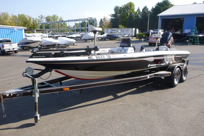 Slide: The Image of 1999 Viper Boats Cobra 201 on trailer, parked outdoors near blue building. - 4