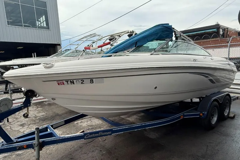 Slide: The Image of 2000 Chaparral 196 SSi boat on trailer, parked outdoors near a building. - 1