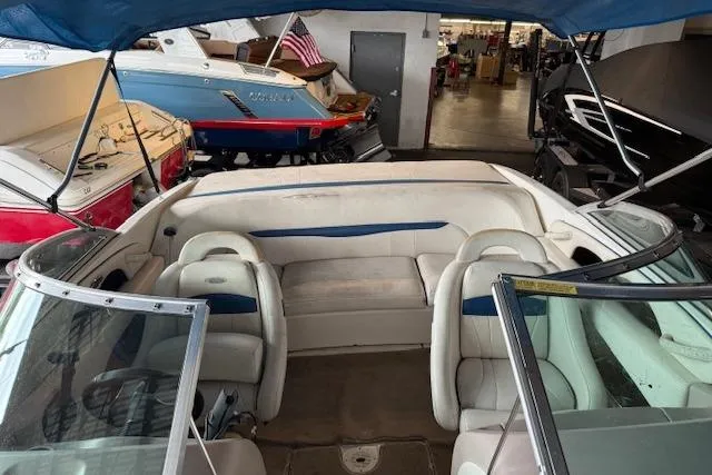 Slide: The Image of 2000 Chaparral 196 SSi boat interior with white seating and blue accents in a showroom. - 10
