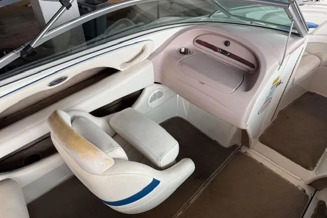 Slide: The Image of Interior of a 2000 Chaparral 196 SSi boat, featuring white seating and dashboard. - 13