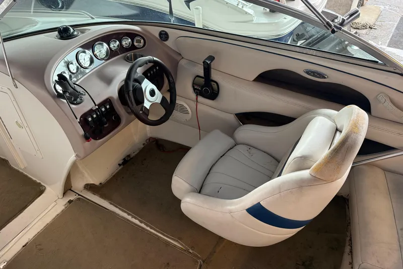 Slide: The Image of Interior of a 2000 Chaparral 196 SSi boat showing steering wheel and dashboard controls. - 16