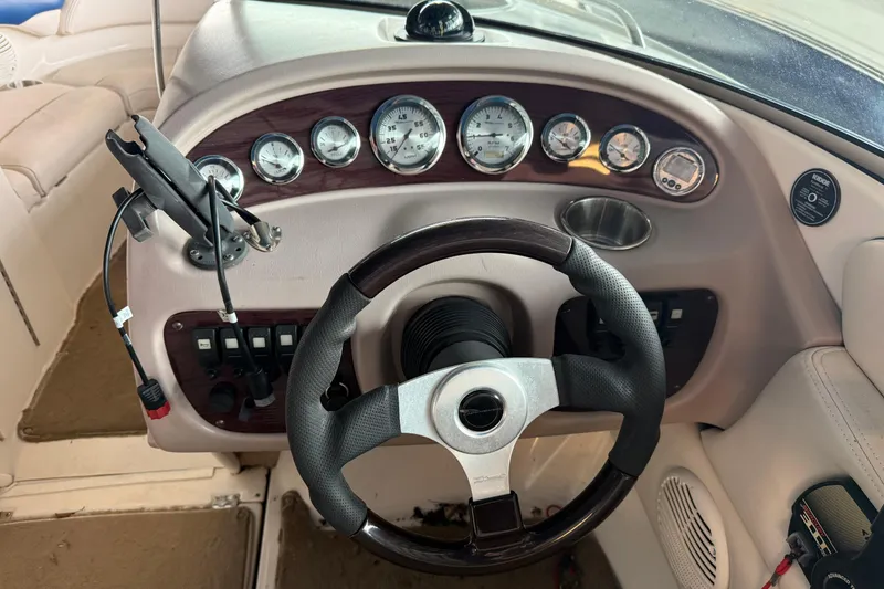 Slide: The Image of Steering wheel and dashboard of a 2000 Chaparral 196 SSi boat, featuring gauges and controls. - 17