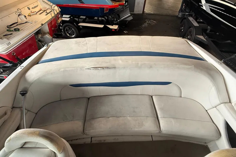 Slide: The Image of Interior seating of a 2000 Chaparral 196 SSi boat, featuring white and blue upholstery. - 19