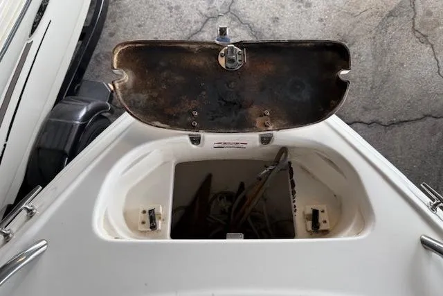 Slide: The Image of Open anchor compartment on a 2000 Chaparral 196 SSi boat, showing storage space. - 7