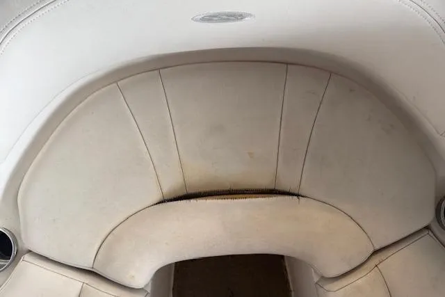 Slide: The Image of White leather seating in a 2000 Chaparral 196 SSi boat, showing slight wear. - 9