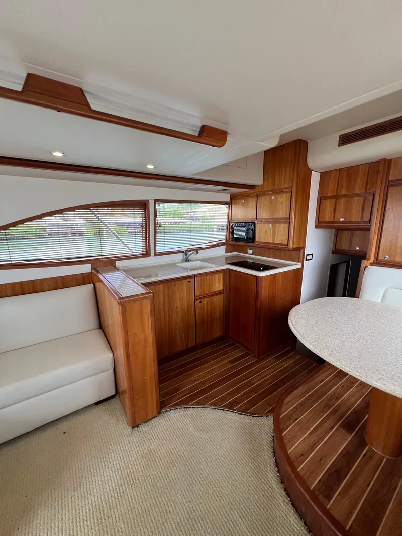 Slide: The Image of Interior of a 2009 Bertram Convertible yacht with wood finishes and modern amenities. - 13