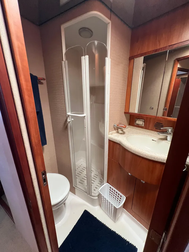 Slide: The Image of 2009 Bertram Convertible yacht bathroom with shower, sink, and toilet. - 17