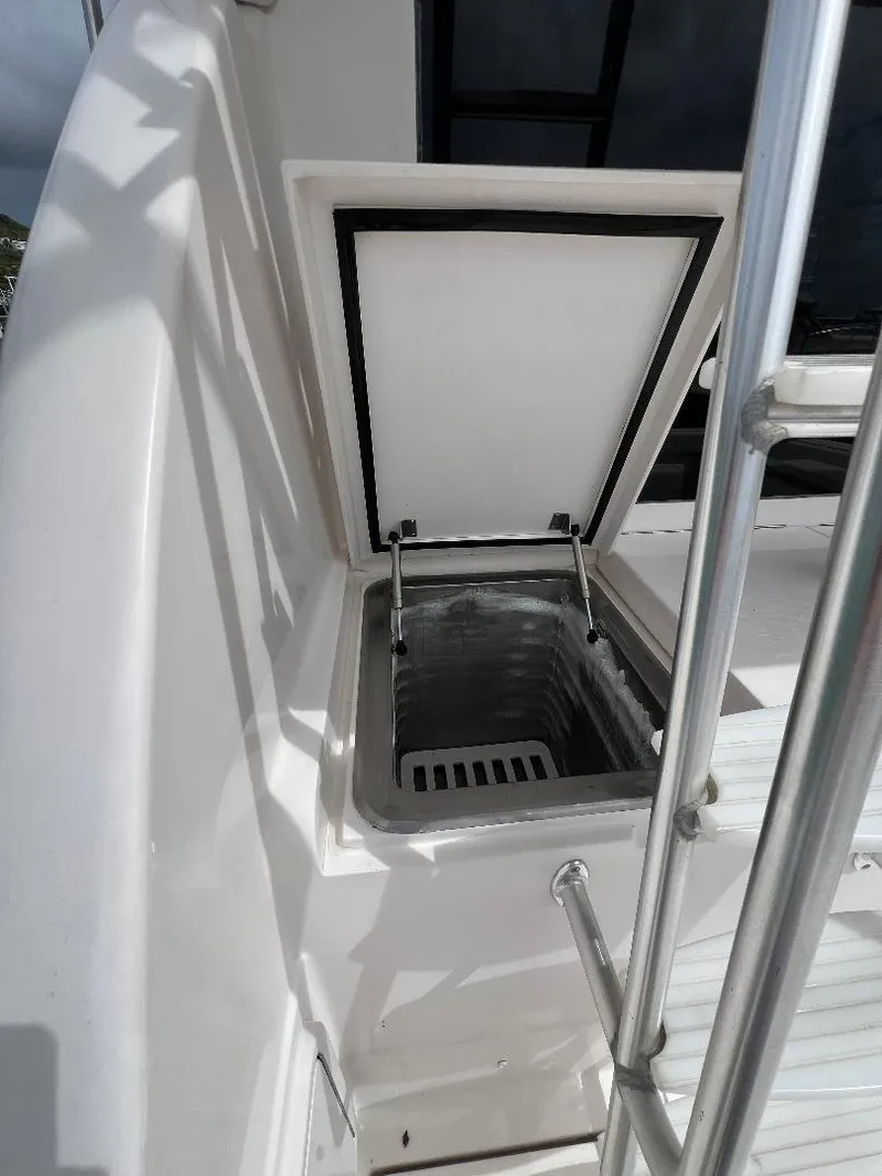 Slide: The Image of 2009 Bertram Convertible boat with open storage compartment. - 4
