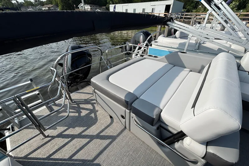 Slide: The Image of 2024 Godfrey SW2286SFL pontoon boat with comfortable seating and sleek design on the water. - 10