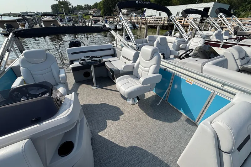Slide: The Image of 2024 Godfrey SW2286SFL pontoon boat interior with plush seating and modern design. - 3